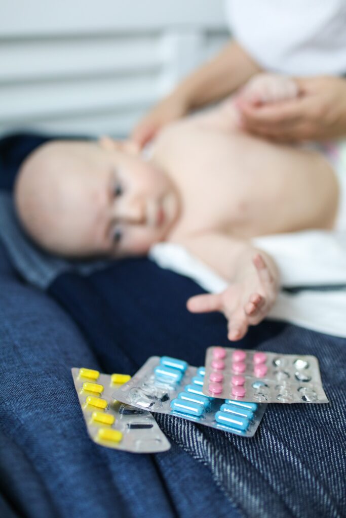 baby reaching for medicines